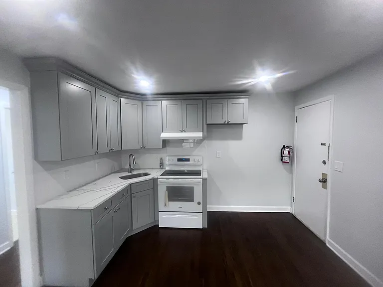 front door goes right into the open kitchen. Newly renovated; electric stove.