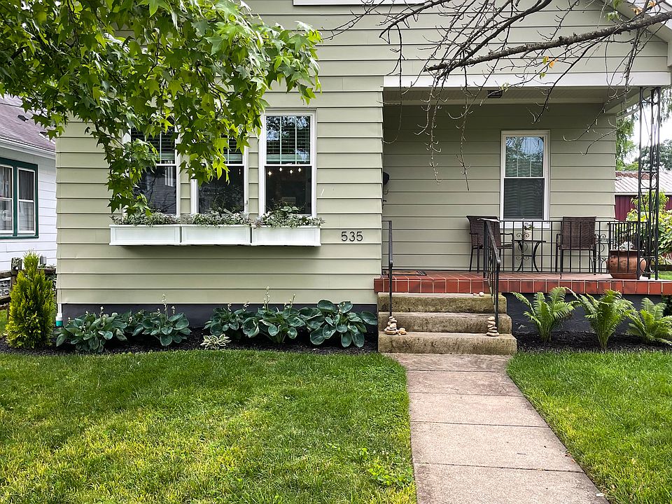 Front of house. Window boxes. Porch. Low maintenance landscaping.