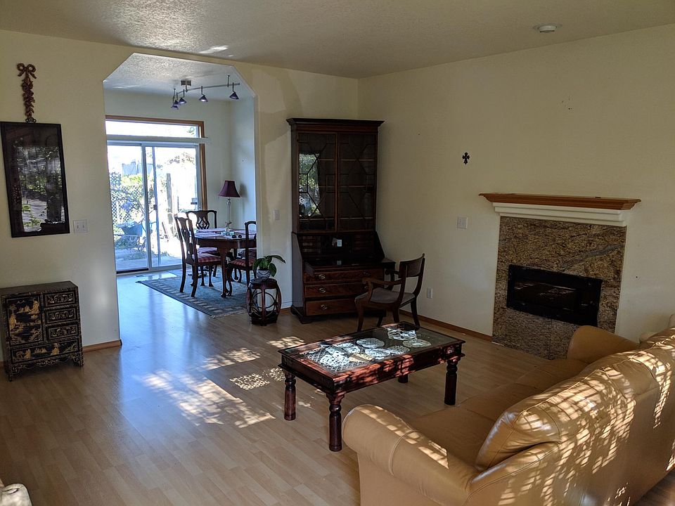 Living room with a large window in front. Bringing lots of light from the dining room sliding door.