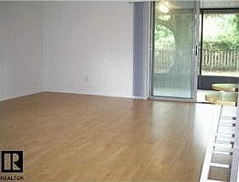 Newer laminate leads out to screened porch