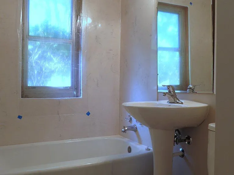 Cultured marble shower siding. Note that a translucent block window has now been installed.
