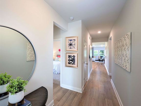 Off the foyer, secondary bedrooms are separate from your primary suite