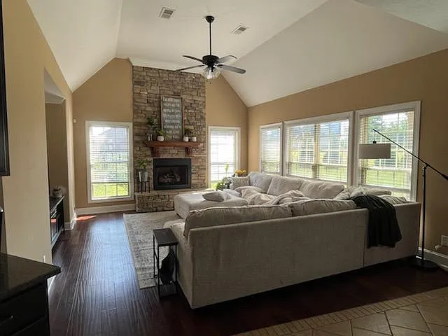 Spacious Family room with stone gas fireplace and abundant windows.