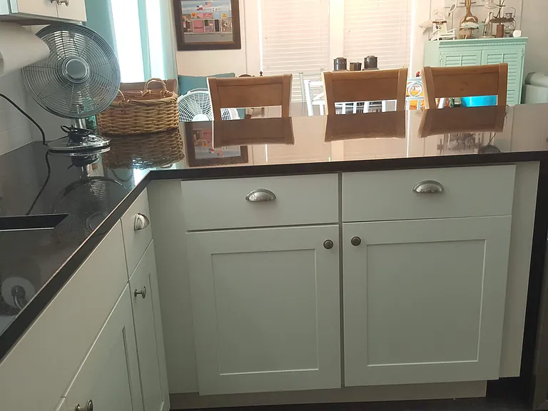Kitchen with 4 bar stools and beverage cooler