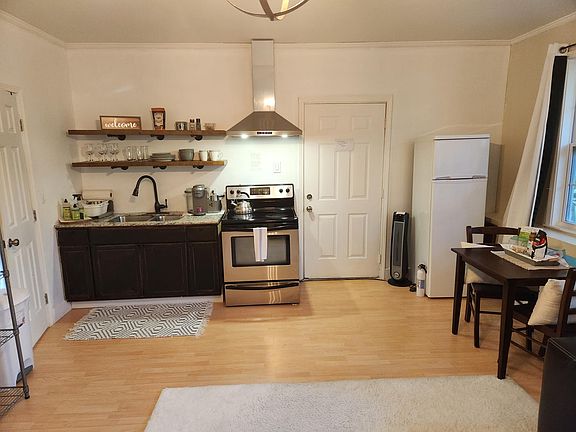 Gallery kitchen, door leading to office/ entrance with washer dryer.