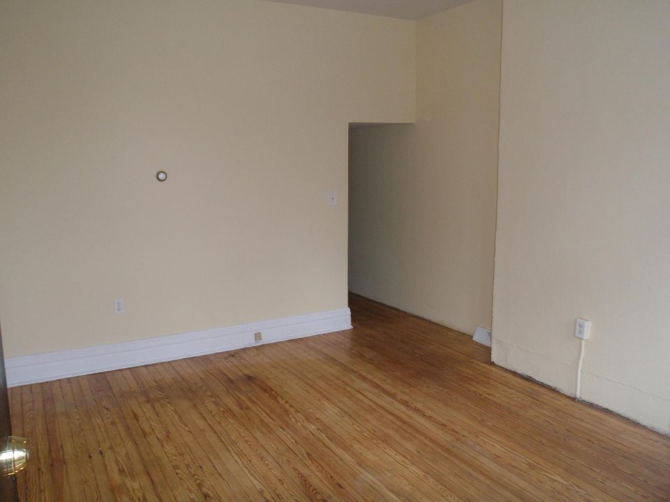 Large living room with beautiful refinished pine flooring.
