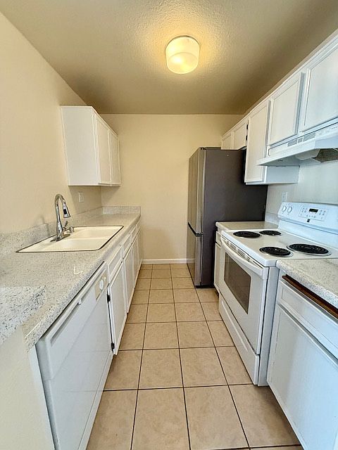 Kitchen includes a stove and refrigerator