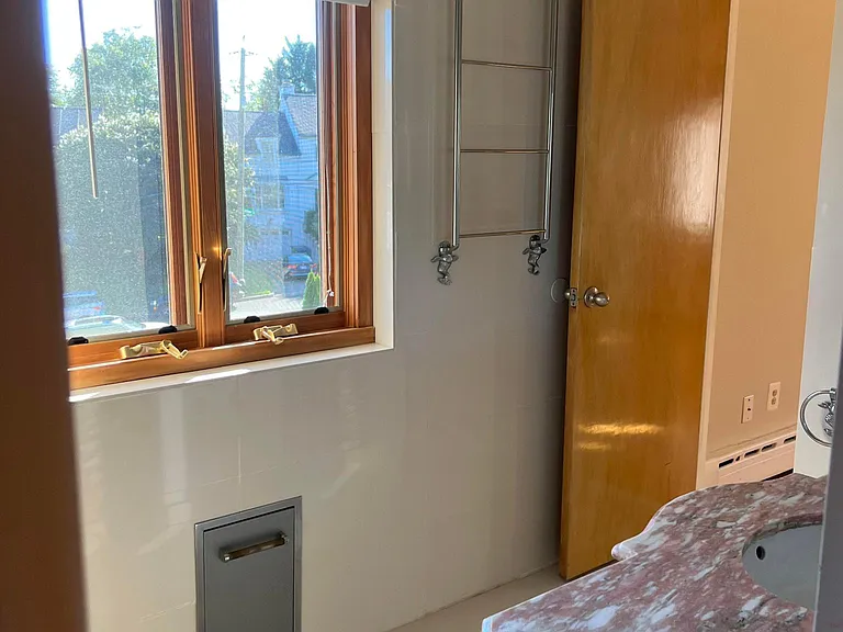 another master bath view with built in scale, and stainless steel bath towel rack