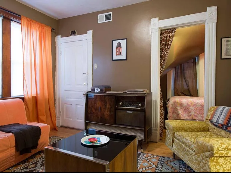 staged photo of living room with office / small bonus third bedroom beyond