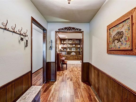 Entry view that shows the direction toward three of the bedrooms and a view of the living area.