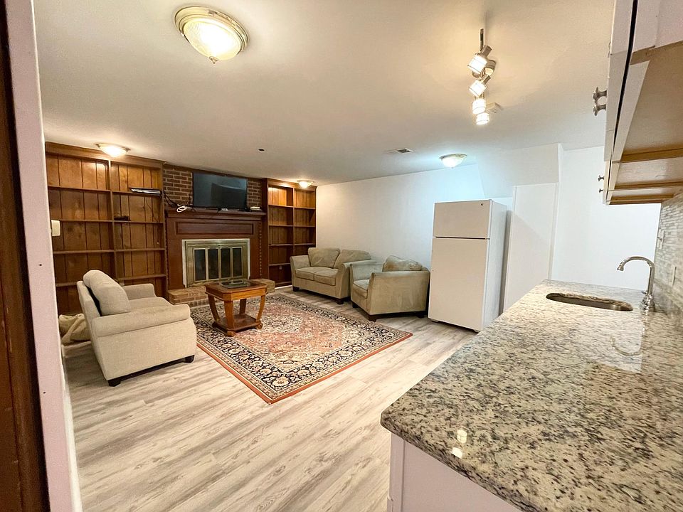 Cozy and convenient, Living Room/Kitchen combo shows wood-burning fireplace