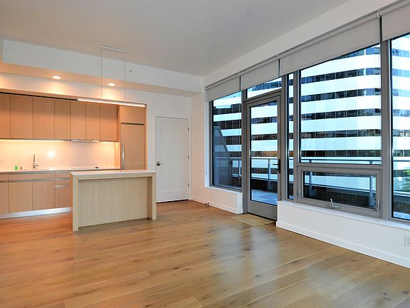 View from Living Room area to kitchen area. Door shown is access to the units' private exterior deck area.