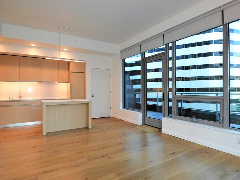 View from Living Room area to kitchen area. Door shown is access to the units' private exterior deck area.