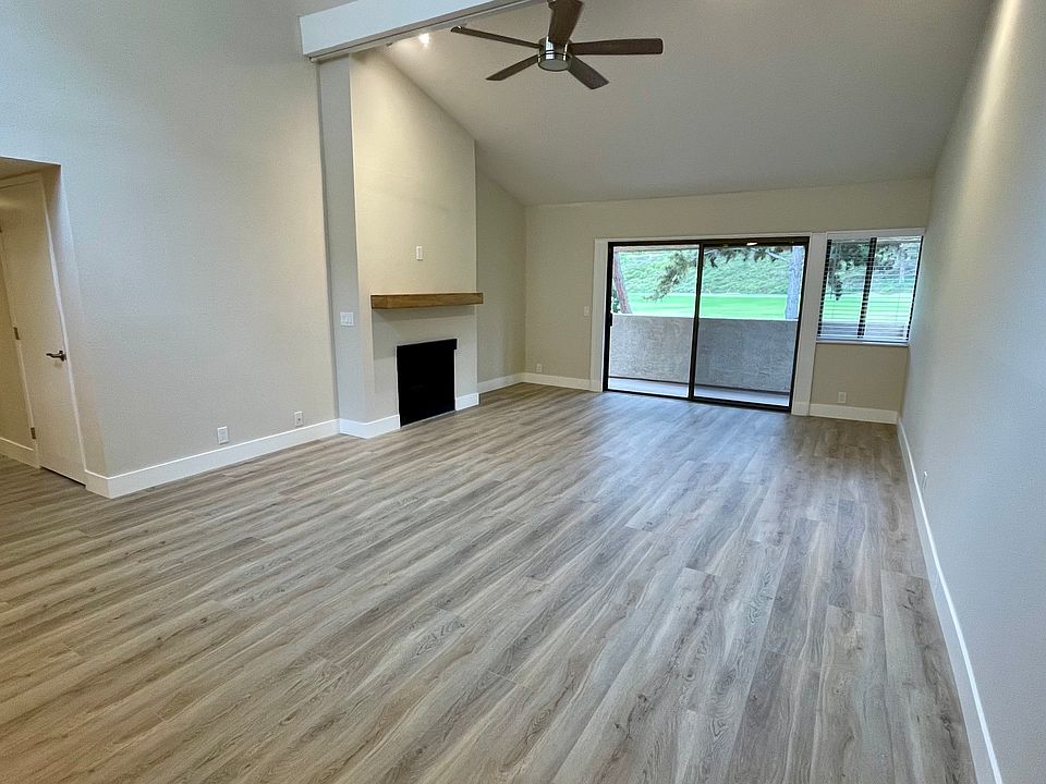 Spacious great room with soaring vaulted ceilings, expansive windows, and an abundance of natural light