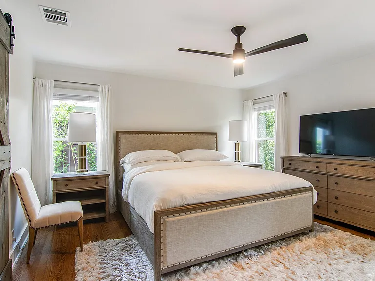 Master bedroom. Irish linen duvet and plenty of storage space in dresser, armoire, and closet and under king bed.