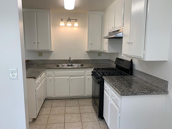 Kitchen with a brand new gas 5 burner range oven, kitchen faucet which swivels and has a pull out spray, and garbage disposal. Granite counter tops and place on the left side for your refrigerator.