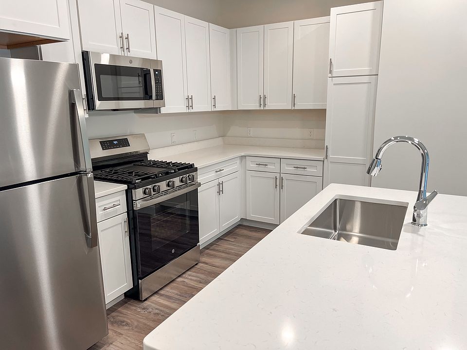 Kitchen with stone counters and stainless steel appliances