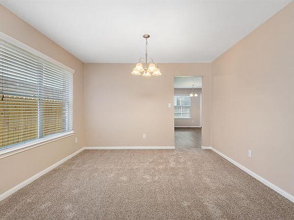From the formal living room into the formal dining room. New light fixture.