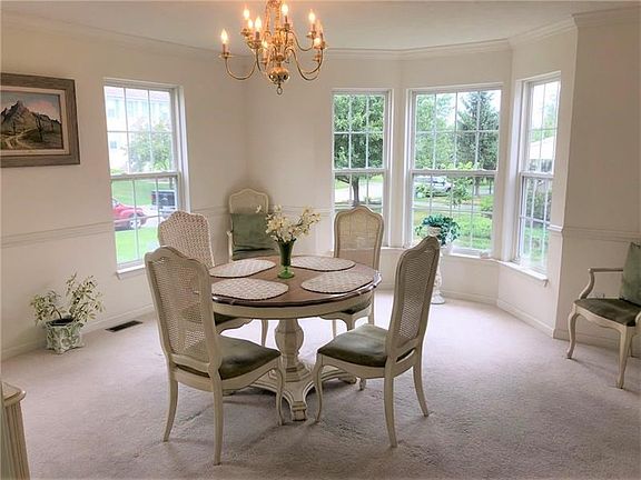 Dining Room. The dining room features neutral colors and both chair and crown molding. Dine here and enjoy wonderful neighborhoo