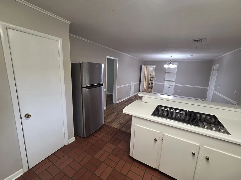 Kitchen looking toward dining room. Note gas stovetop.