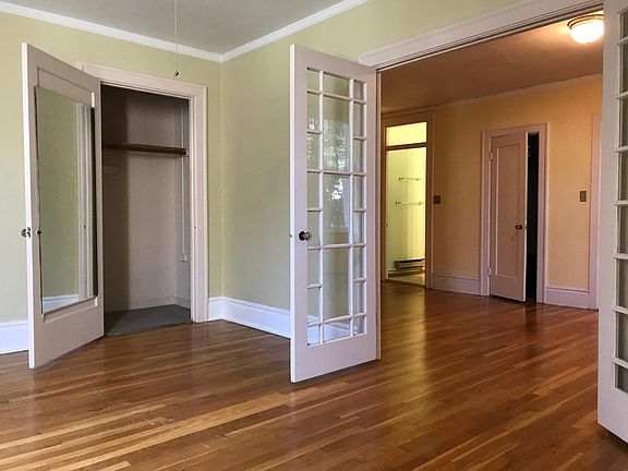 Bedroom features large, full-length closet and French windows for open, airy space.