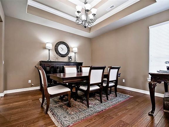 Spectacular Architectural Detailing in this Formal Dining Room just off Entry with Double Tray Ceilings, Pretty Crown Molding & Updated Hardwood Flooring...