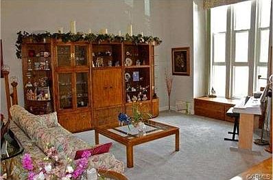 Expansive living room with soaring windows and built-in window s