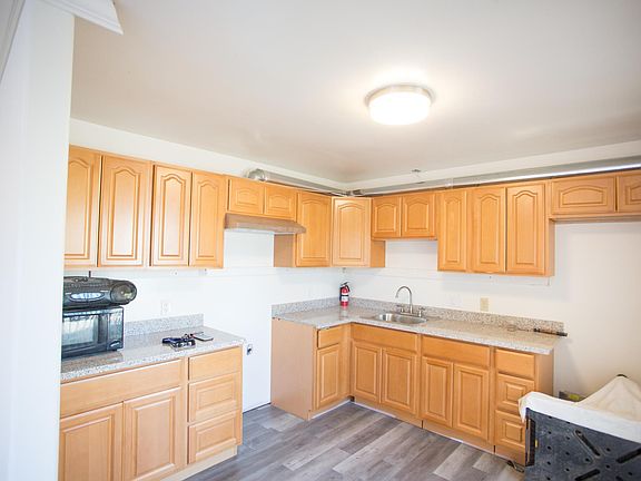 Large kitchen with new countertops, cupboards, floors and stove/kitchen(to be installed before move-in)