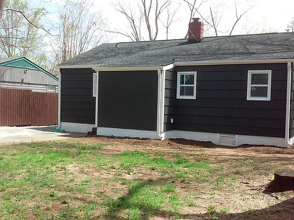 Back yard is sunny, flat and partially fenced.