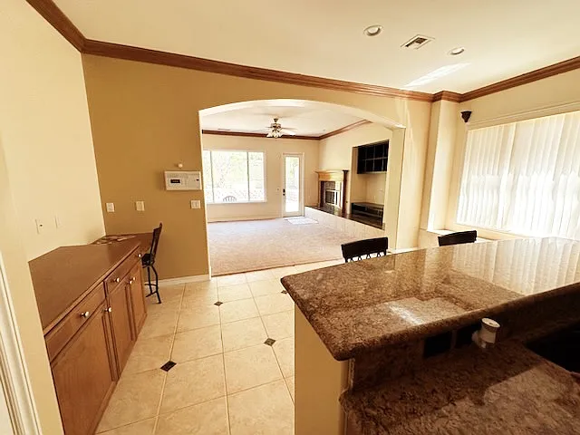 Open Concept Social Area.
Kitchen, Dinning and Family with entertainment area, fire place with granite & priced wood finishes for the mantle, view of the private open space.