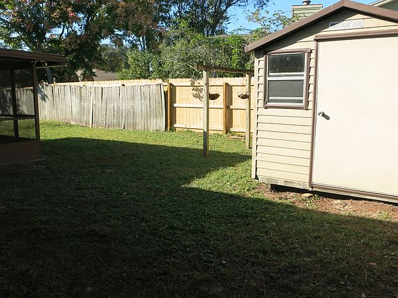 Large fenced yard with shed.