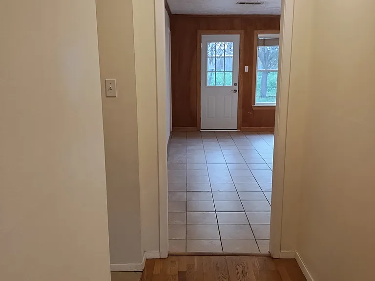View of Entryway into Den with back door shown.