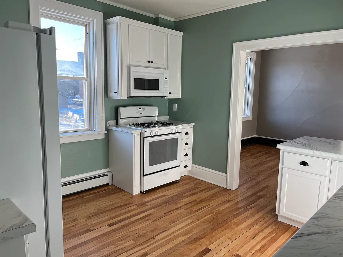Kitchen range and microwave view toward Dining Room. - 415 1/2 E Saint Germain St #3