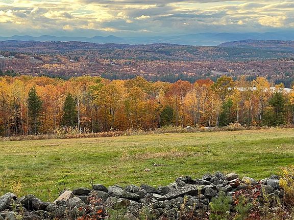 Expansive field, lake and mountain views