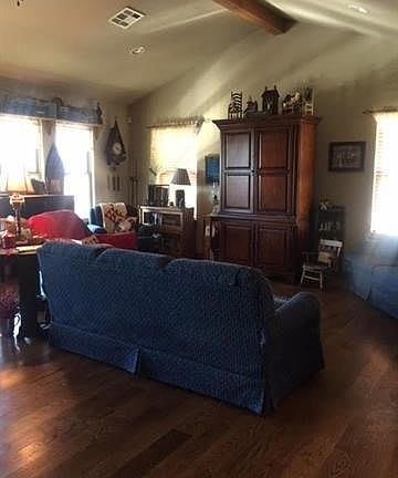 Wood floors, vaulted beamed ceiling and lots of windows