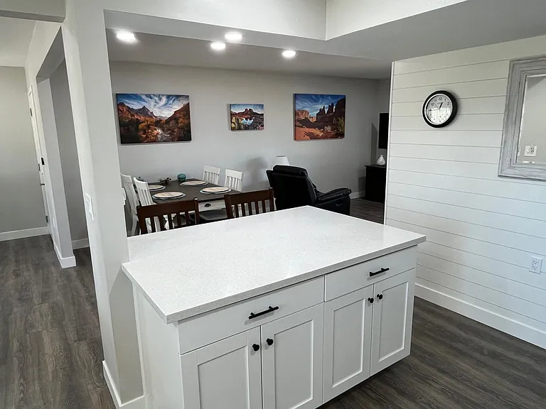 Island is between kitchen and dining area.