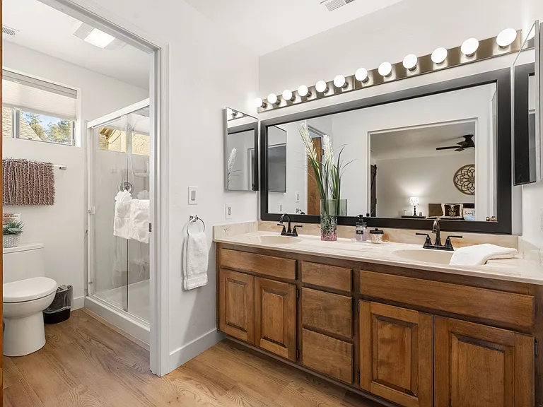 The main bedroom en suite features a double vanity sink and a walk-in shower