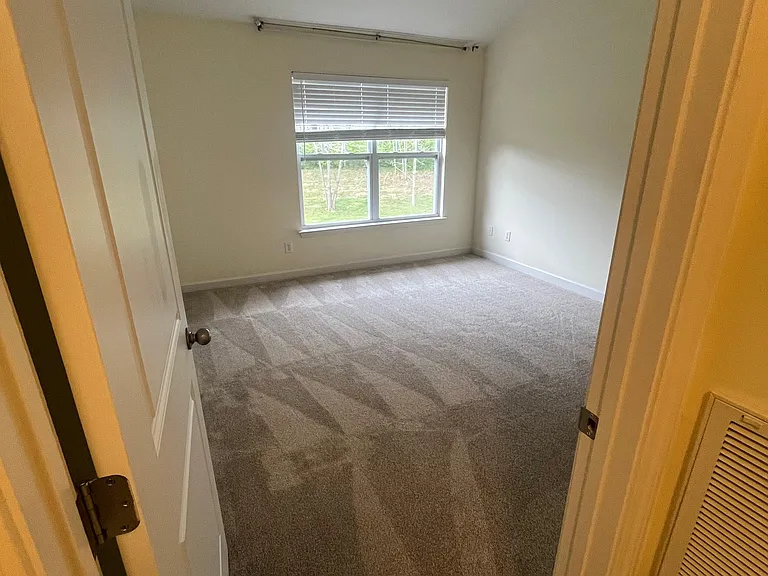 Main bedroom with vaulted ceilings and brand new carpet
