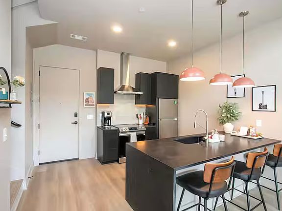 Open concept kitchen + living room with lots of natural light