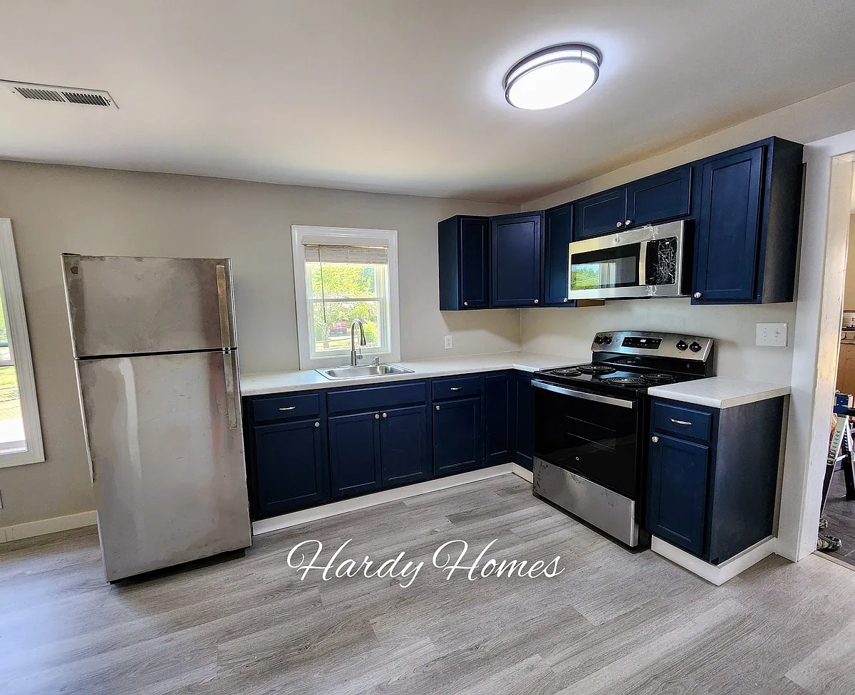 Completely remodeled kitchen with beautiful dark blue cabinets and new stainless steel appliances. - 134 Eclipse St