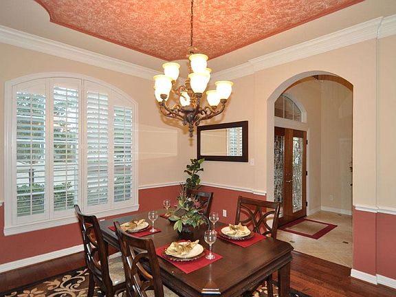 Formal dining with plantation shutters and plenty of natural lighting.