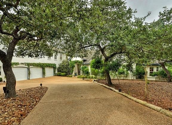 The estate is perfectly positioned on almost 3 acres of wooded bliss.