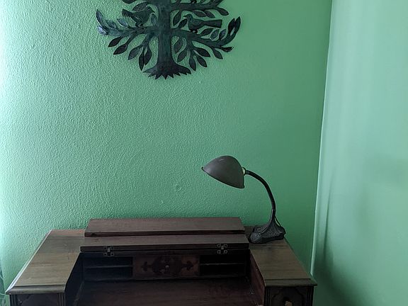 Antique desk with lamp. Each bedroom has a writing desk and a reading chair with overhead light.