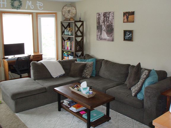 large living room with a space for a desk and natural lighting