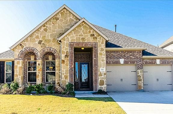 Blakely home with arches and upgraded stone elevation