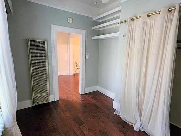 Bedroom with 6' closet, desk/shelf alcove, ceiling fan, 7' window, like new laminate floors