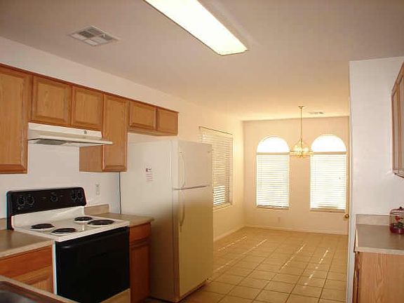 Kitchen view of breakfast area. This is an old photo. There is a microwave installed and a NEW refrigerator and stove will be installed prior to move in