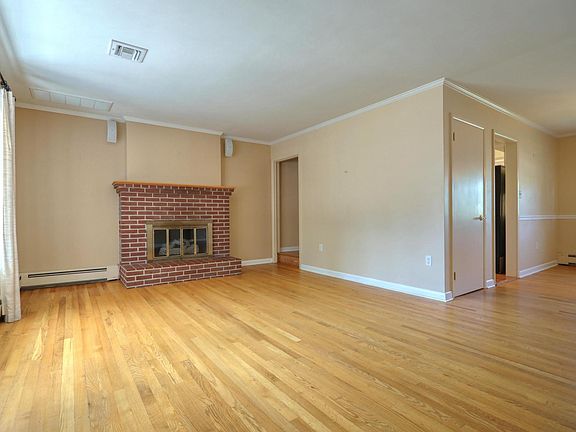Living room with brick hearth and gas fireplace.