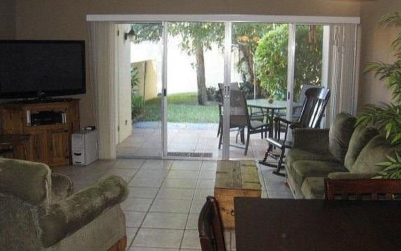 Living room extends out to covered patio with private yard area