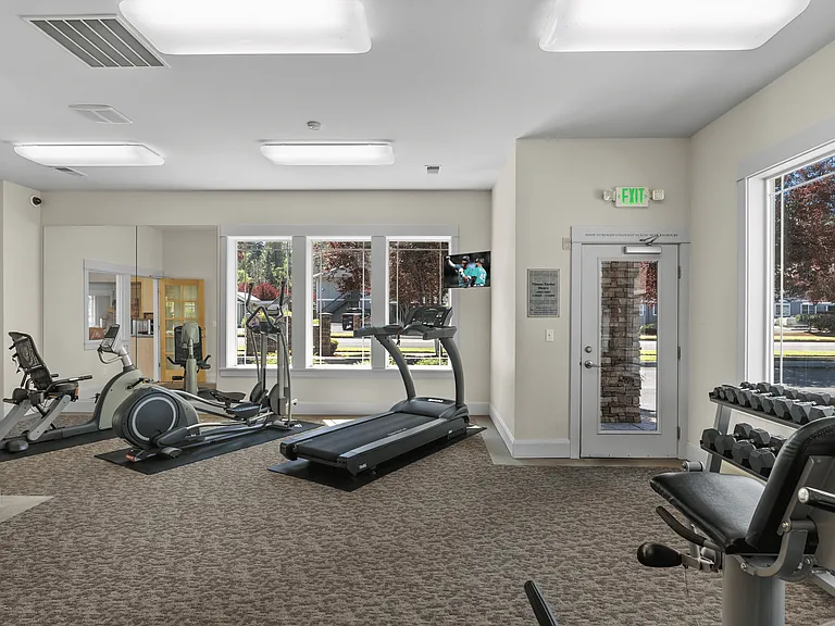 Fully equipped fitness center with cardio, strength machines, and free weights.